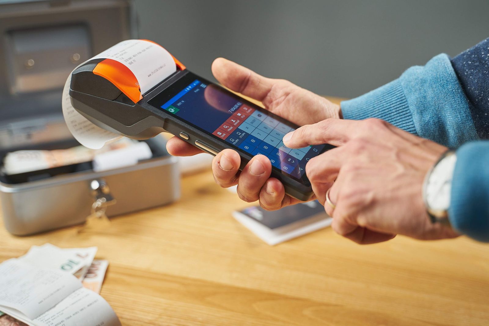 Card, cash and calculator at a seller desk - illustrative