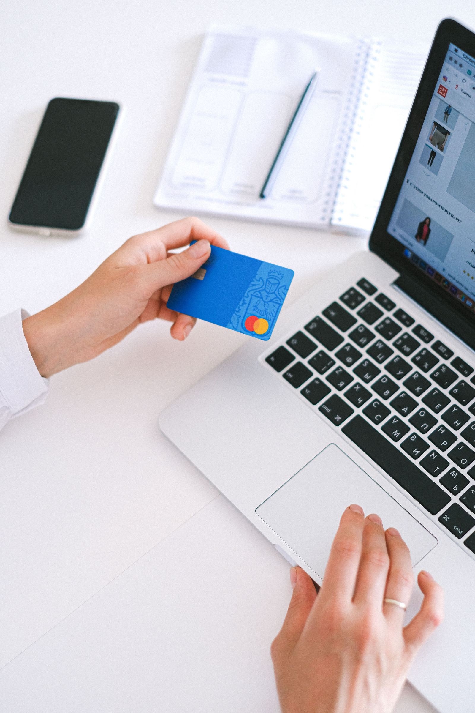 Card, cash and calculator at a seller desk - illustrative